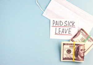 white medical mask, money and paid sick leave text on a blue background